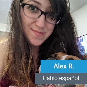 A woman with long brown hair and glasses smiles at the camera while holding a small dog. Text overlay reads "Alex R." and "Hablo español.